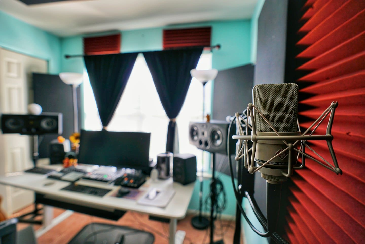 En silverfärgad Neumann-mikrofon i en inspelningsstudio.